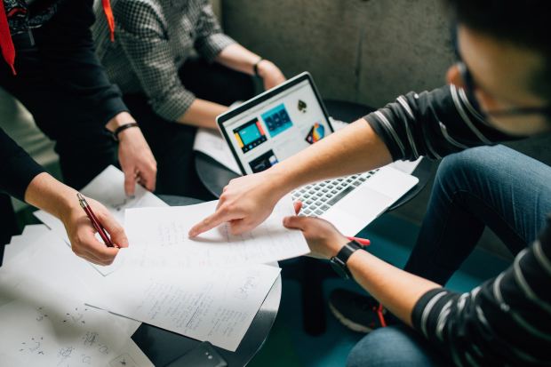 teamwork over computer & paper