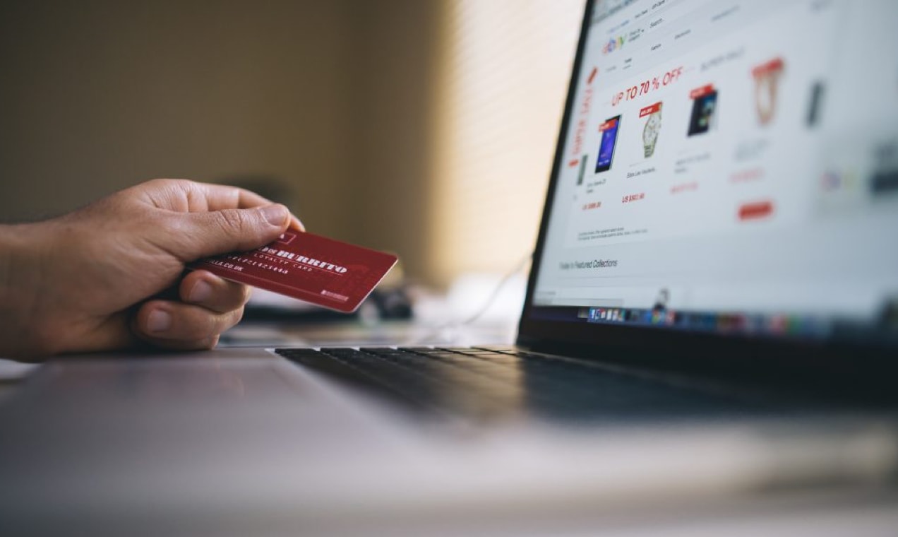 person using a credit card to check out on eBay