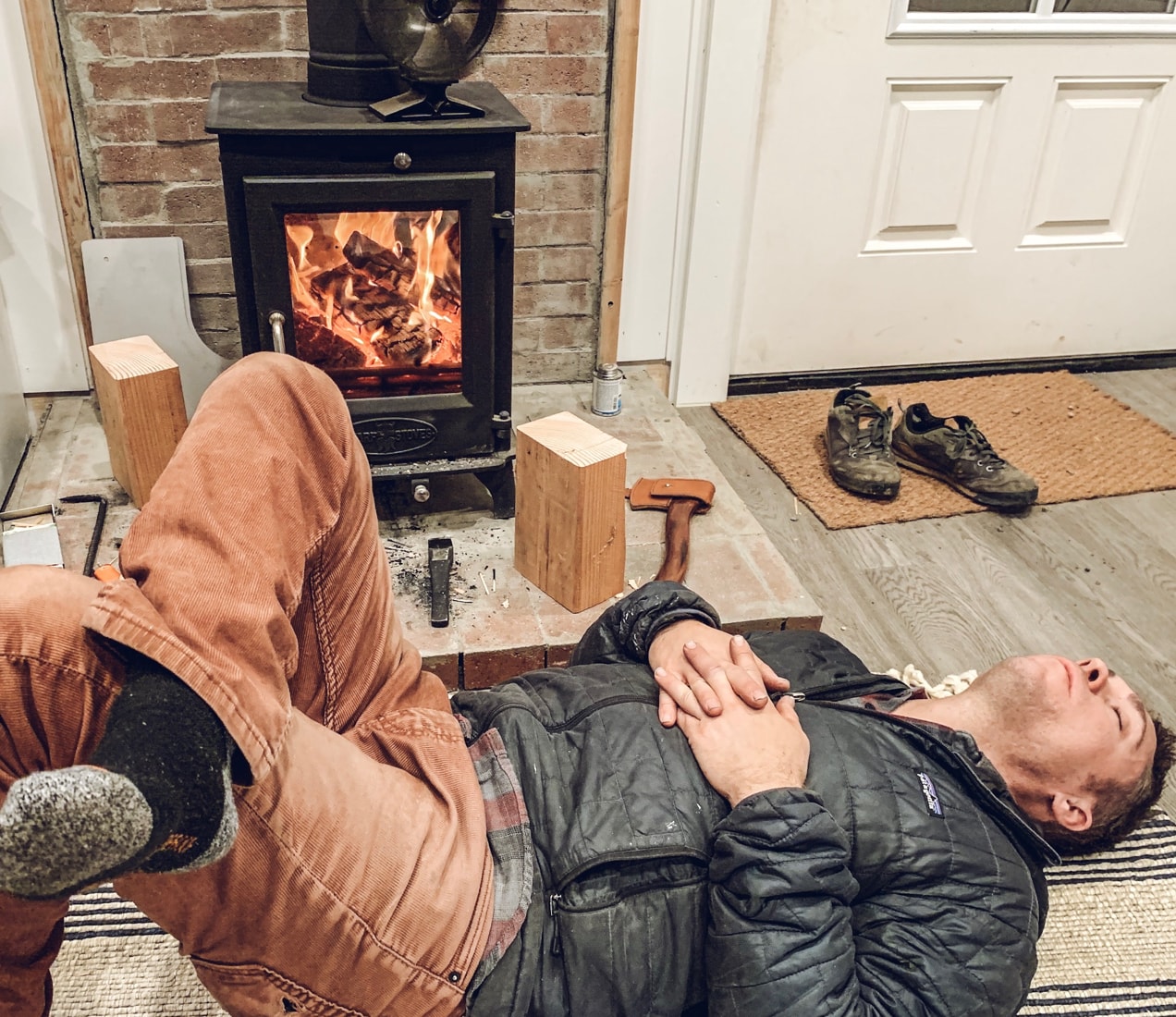 Taking a nap in front of a tiny wood stove