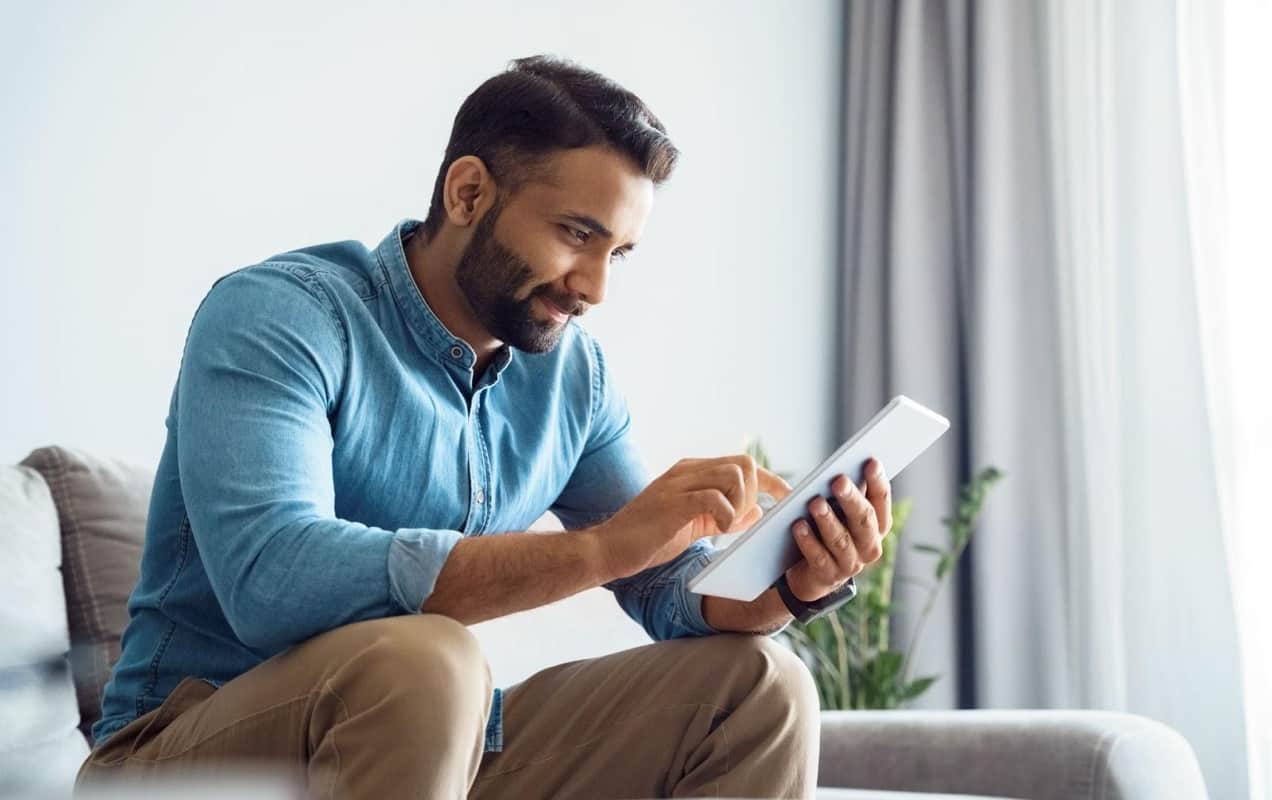 man looking at his tablet