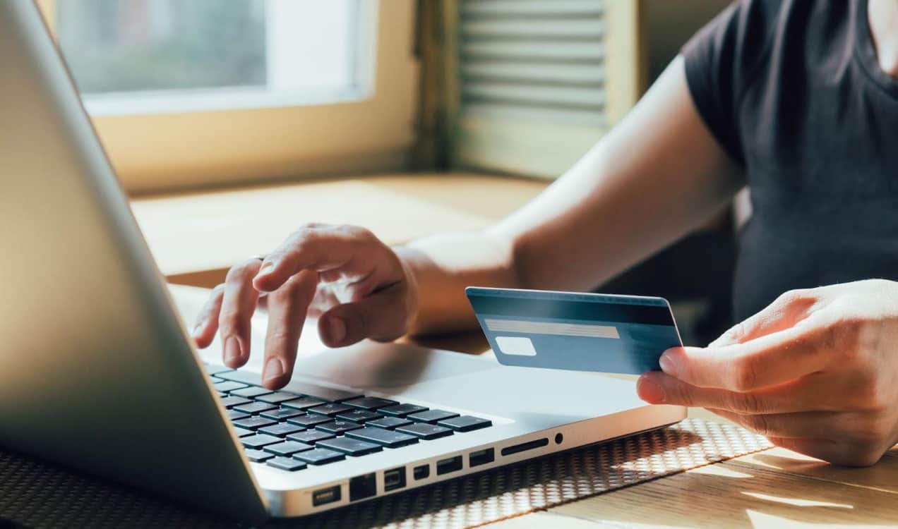 person checking out using a credit card on a laptop