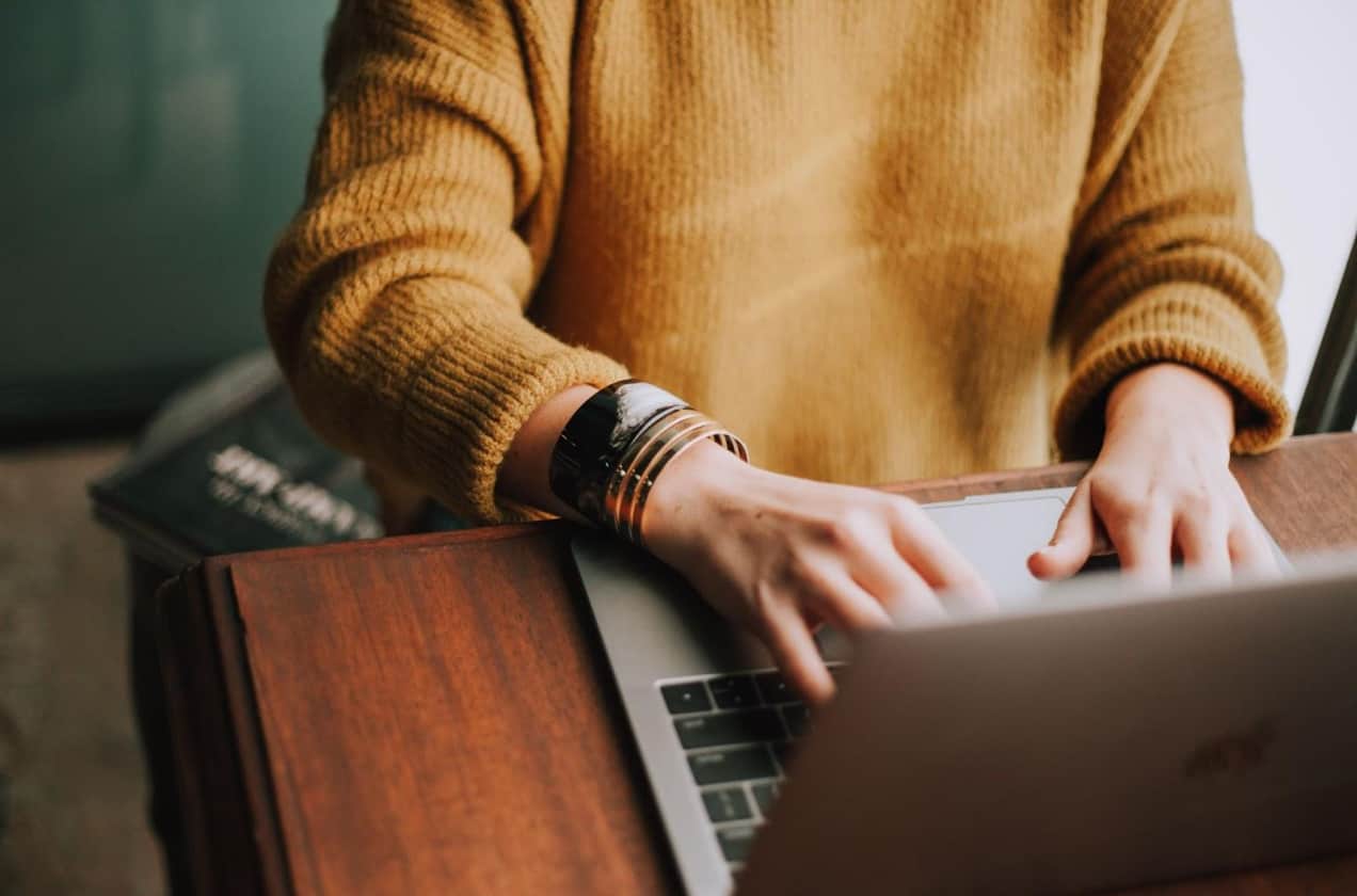 person typing on a laptop