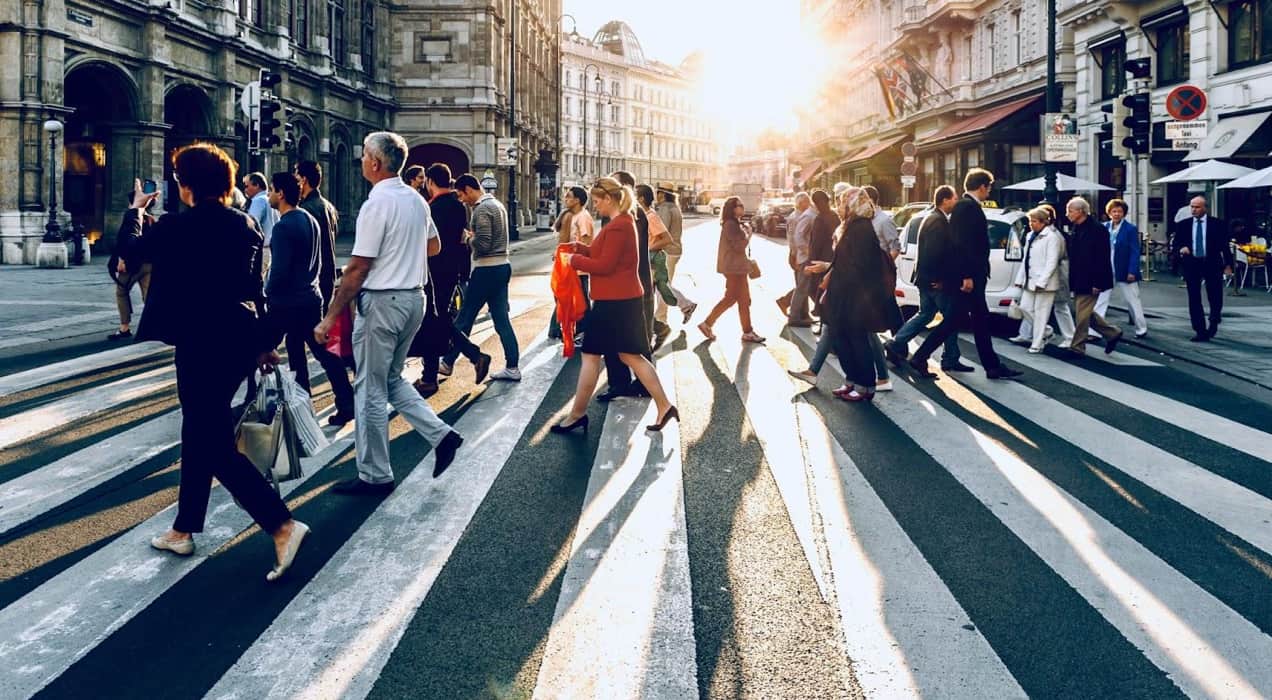 people walking across a busy street