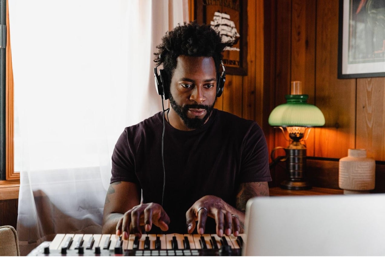 man recording music on a keyboard