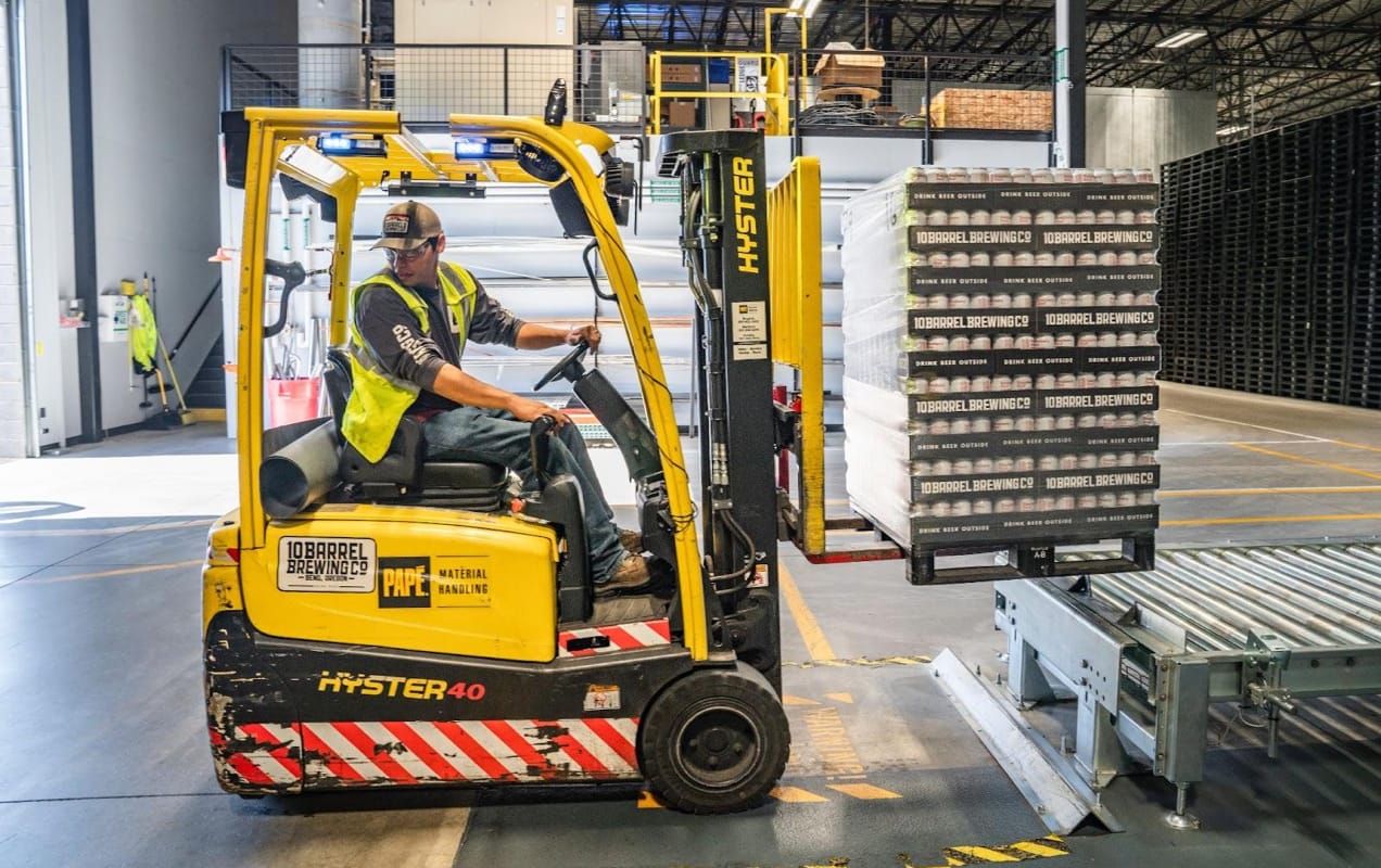 man moving stacks of products around a warehouse