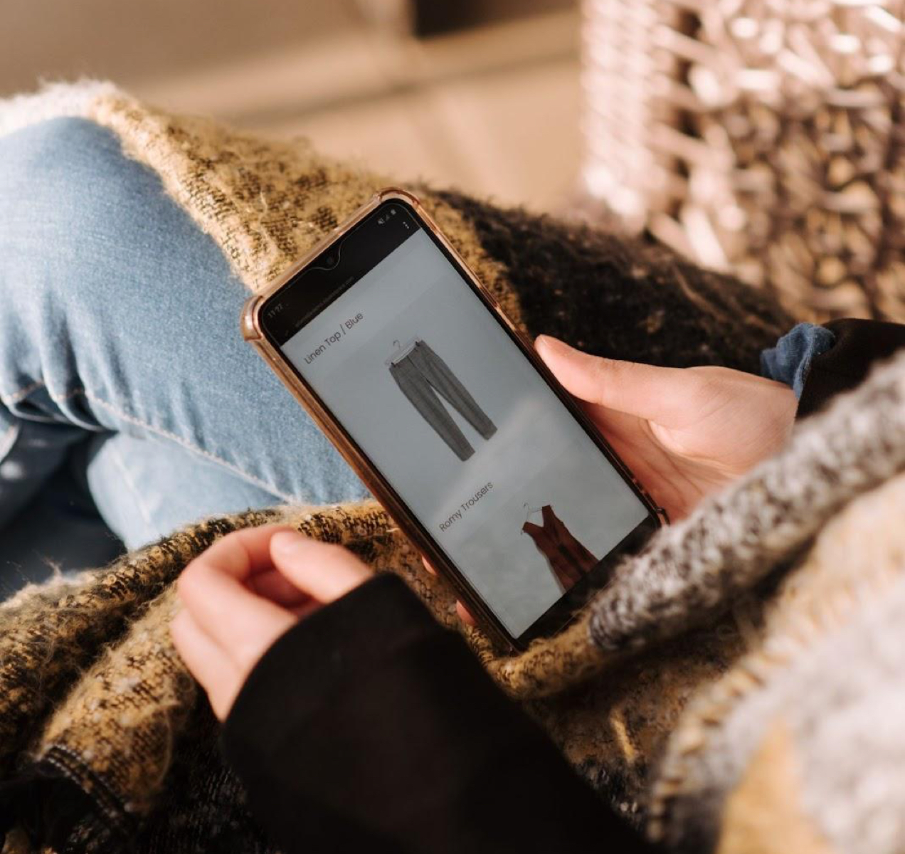 person shopping on a phone on the couch