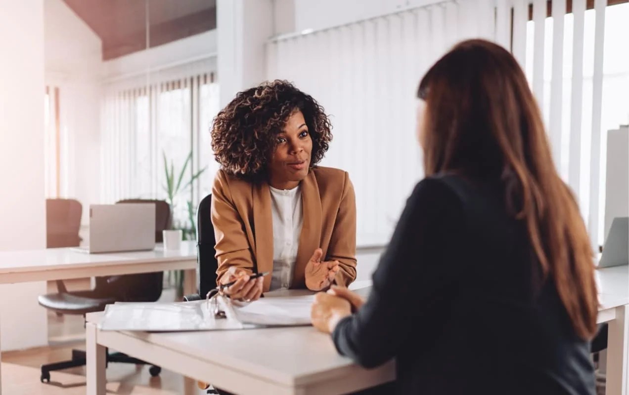 woman meeting with a client at a desk